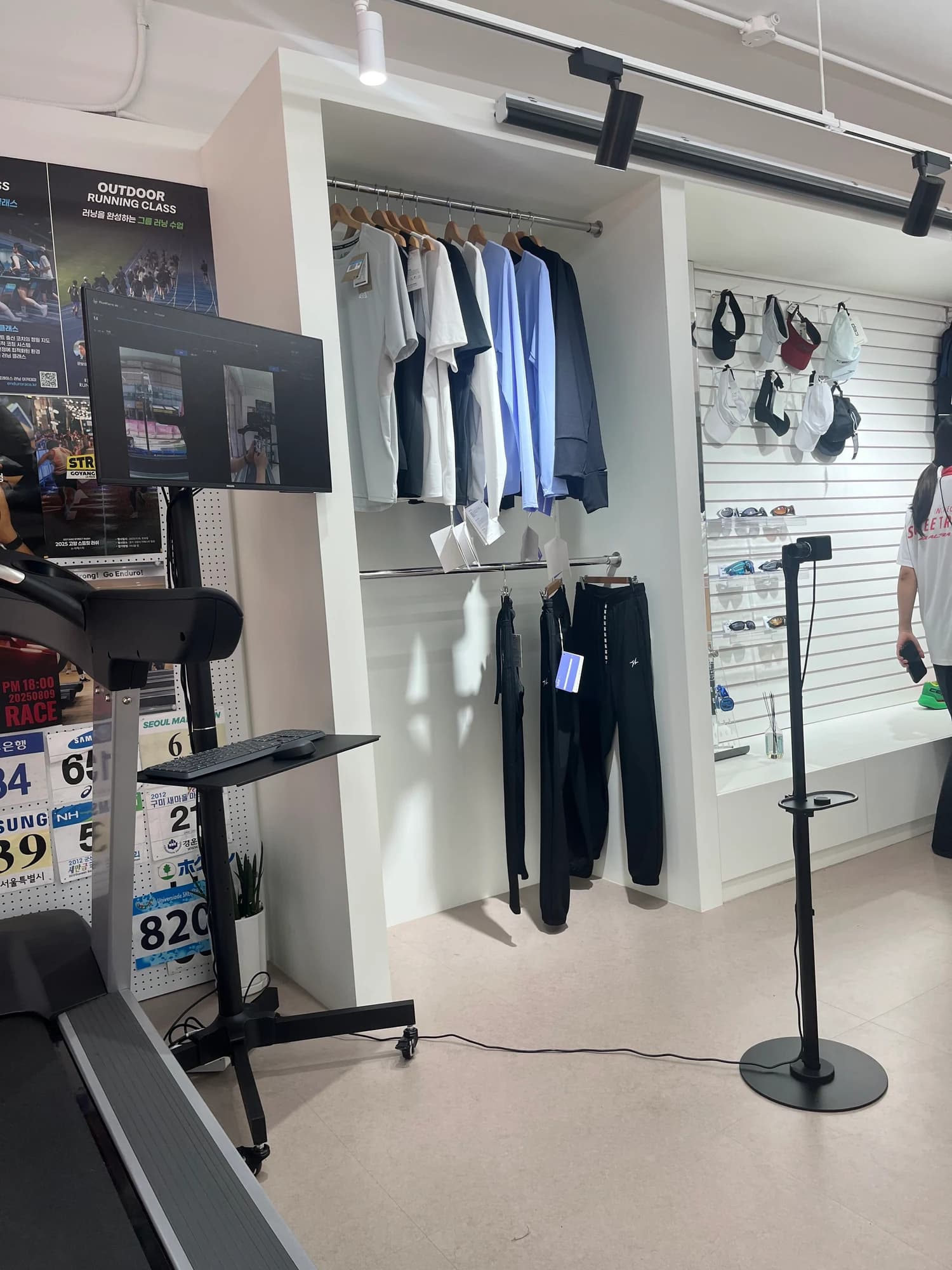 Recording cameras and a monitor positioned in an indoor running space
