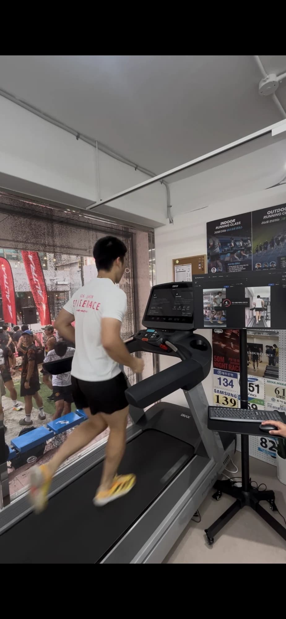 A runner on a treadmill in front of the RunForm AI Pro recording screen